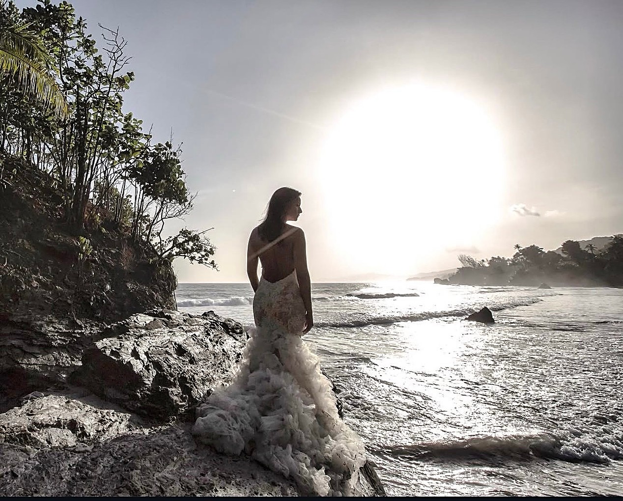 Bride on coastal rocks overlooking the ocean — editorial wedding portrait by Abigail Salazar